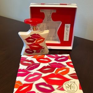 Bond No. 9 Nolita by Bond No. 9 Eau De Parfum Spray   3.3 oz with red lipstick.